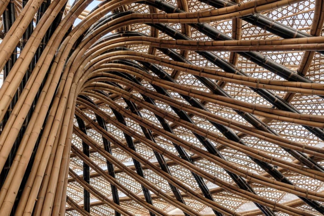 Close-up of the woven bamboo-and-black-batten structural lattice of the Luna Beach Club canopy