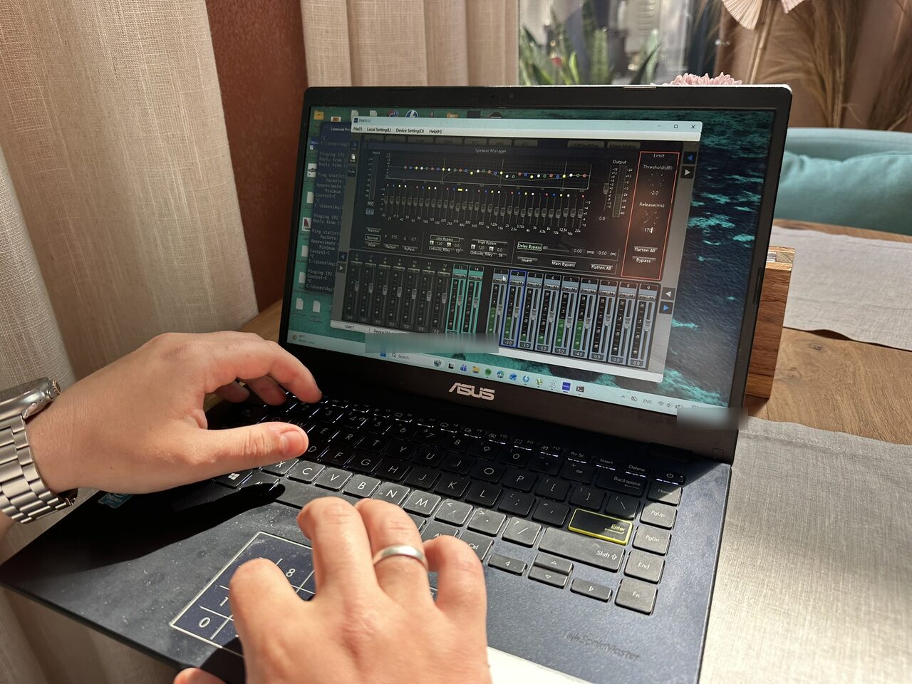A laptop running the DSP matrix speaker-manager during calibration at SILK Restaurant, showing a graphic EQ, a limiter and the input and output channel strips